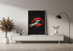 Modern living room with a white console table, decorative plant, and a piece of abstract art featuring red lips and a cigarette.