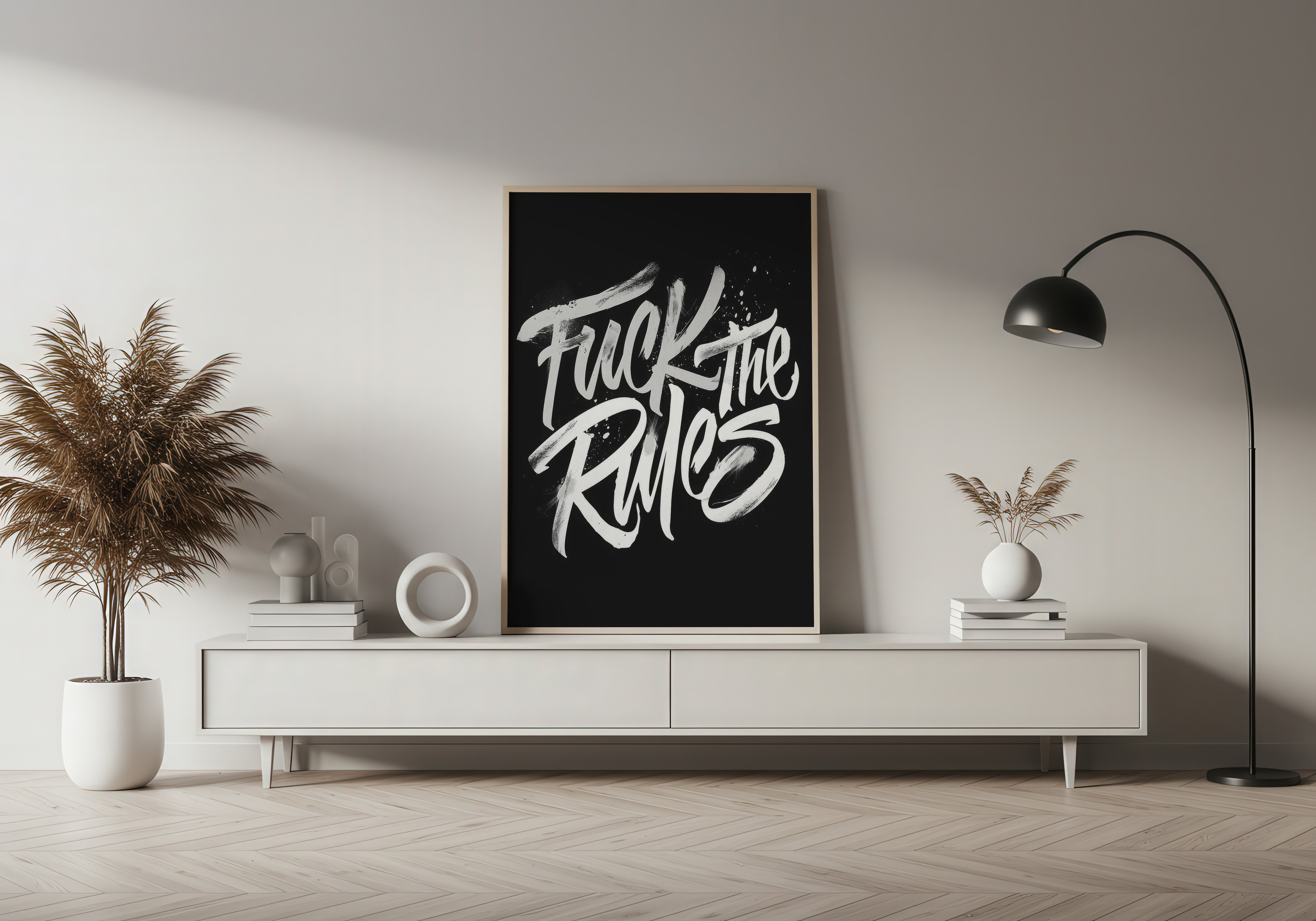 Modern interior with a black frame displaying 'Fuck the Rules' on a white wall.