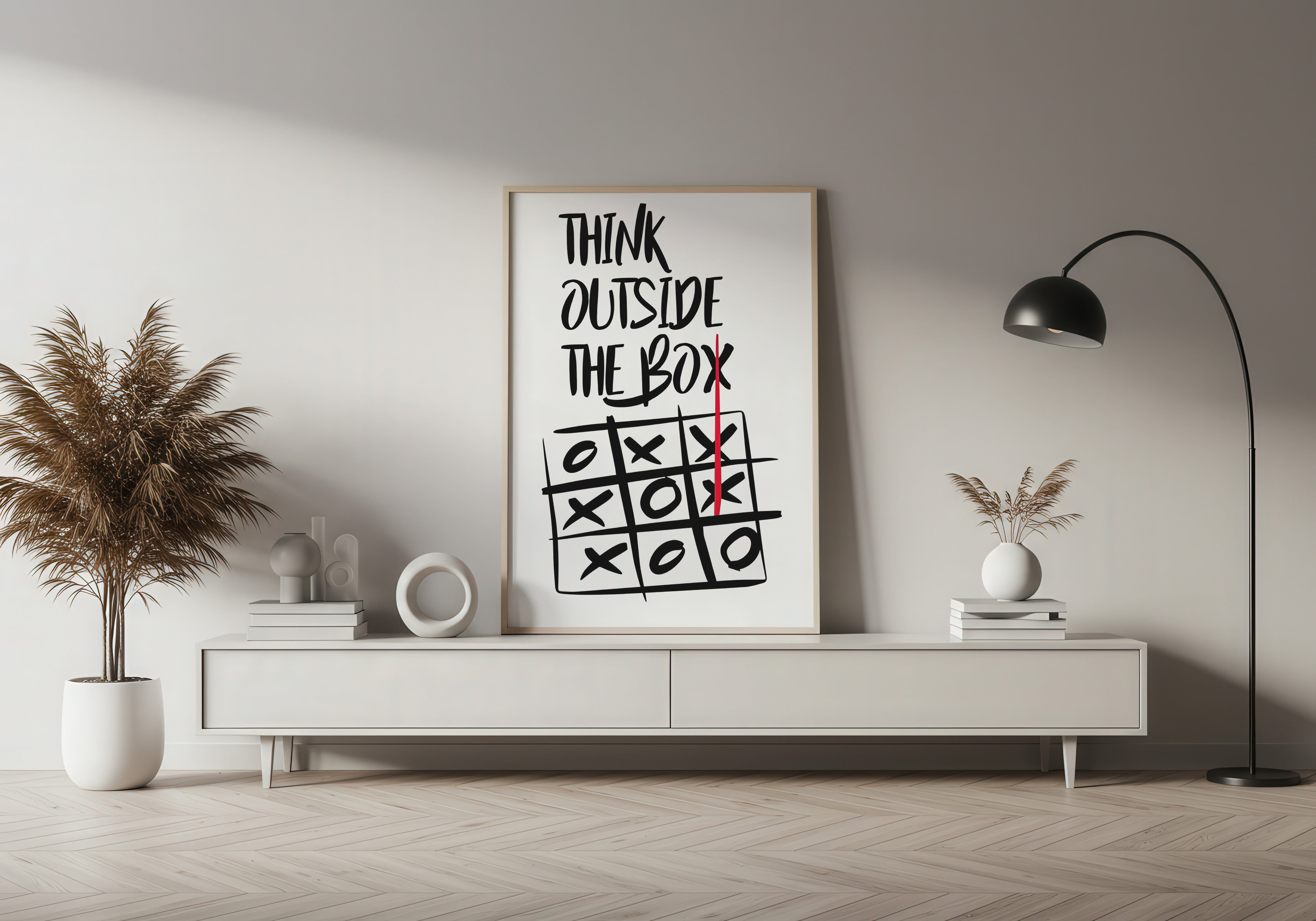 Modern living room with a 'Think Outside the Box' poster on a white wall.