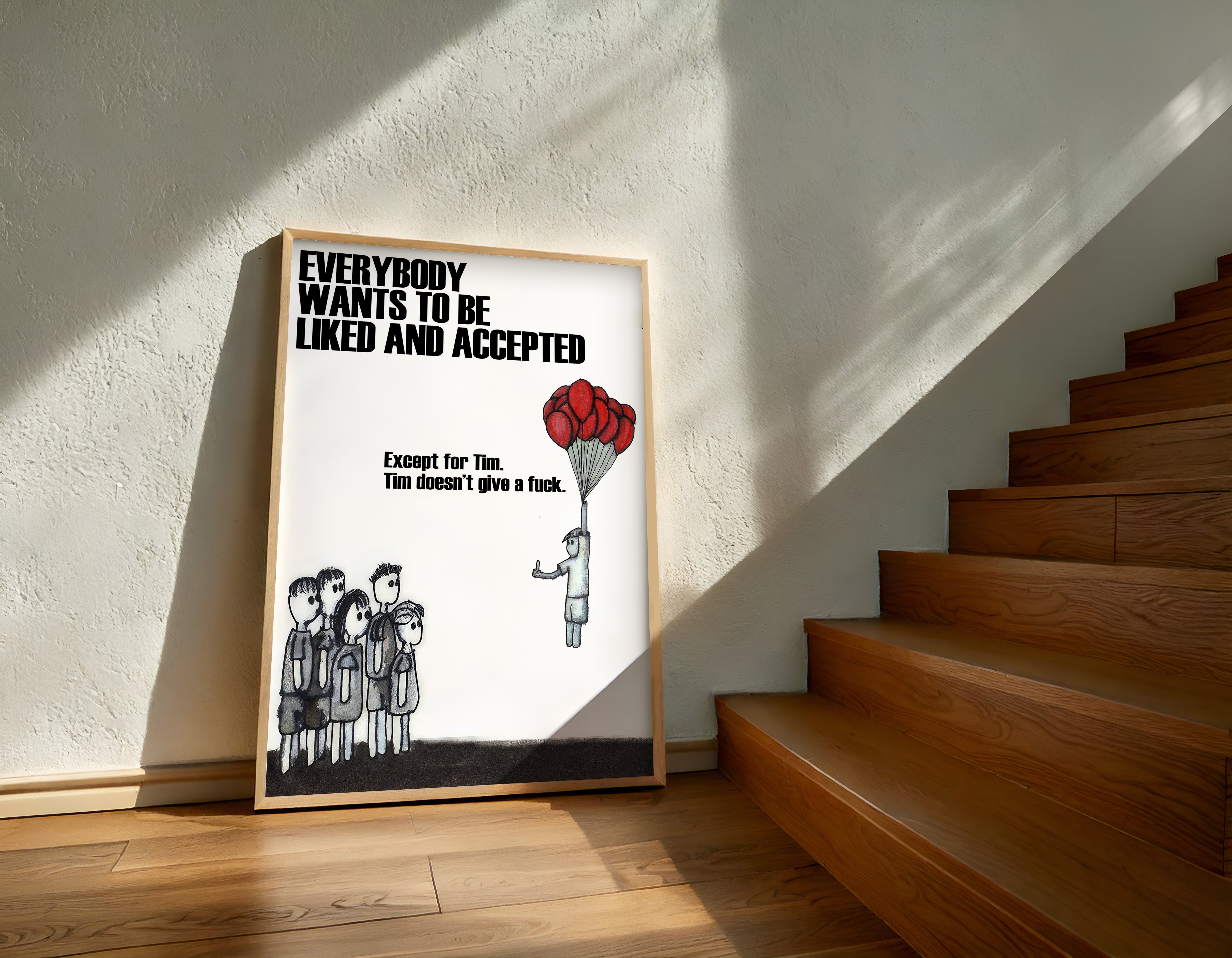Framed poster with a message about acceptance on a wall next to wooden stairs.