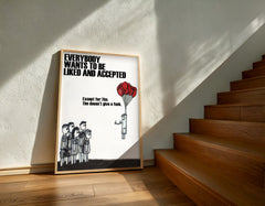 Framed poster with a message about acceptance on a wall next to wooden stairs.