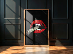 Framed artwork with red lips and a knife on a black background, displayed against a dark paneled wall.