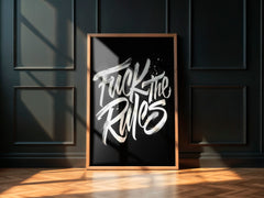Framed poster with 'Fuck the Rules' text on a dark wall.