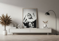 Modern living room with a framed black and white portrait on a white wall.