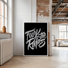 Modern interior with a framed poster displaying 'Fuck the Rules' in a stylish room.