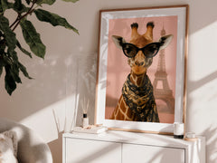Framed artwork of a giraffe wearing sunglasses with the Eiffel Tower in the background, displayed on a white surface.