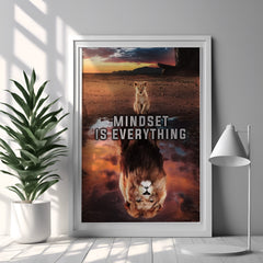 Framed poster with a lion and reflection, featuring the quote 'Mindset is Everything', in a room with a plant and lamp.
