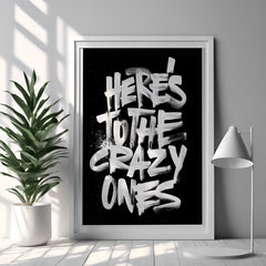 Framed poster with 'Here's to the crazy ones' text in a modern interior setting.
