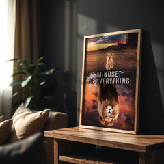 Framed motivational poster with a lion design on a wooden table in a living room.