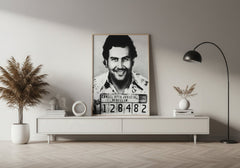Framed mugshot of a man on a wall in a modern living room.