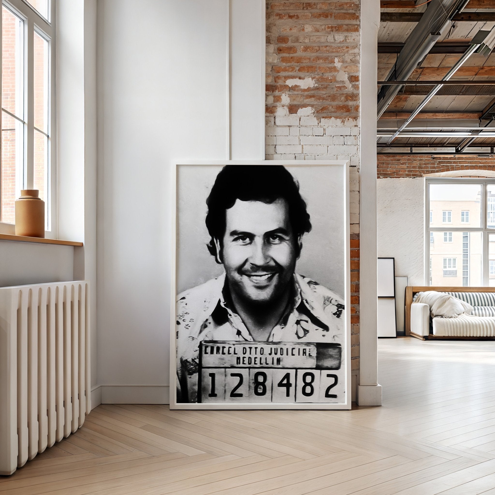 Framed black and white portrait of a man in a room with modern decor.