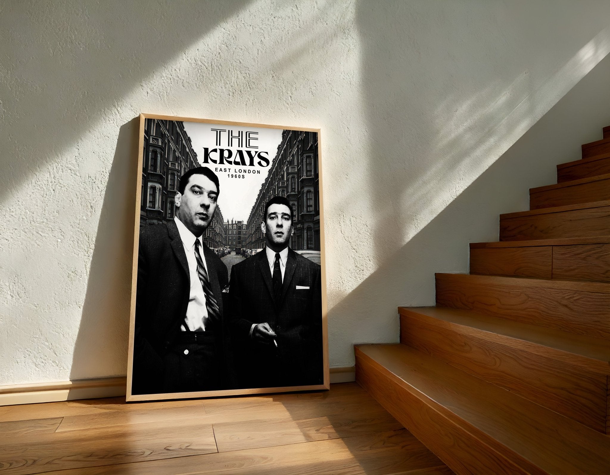 Framed poster of 'The Kray Twins' on a wall next to wooden stairs