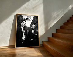 Framed poster of 'The Kray Twins' on a wall next to wooden stairs