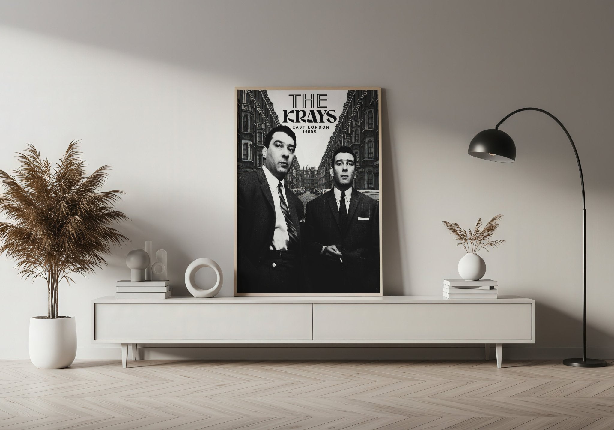 Poster of 'The Kray Twins' on a wall above a white console table in a room with decor elements.