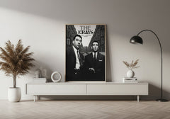 Poster of 'The Kray Twins' on a wall above a white console table in a room with decor elements.
