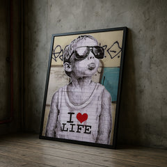 Framed artwork of a child wearing sunglasses and a 'I ❤️ LIFE' shirt against a textured wall.