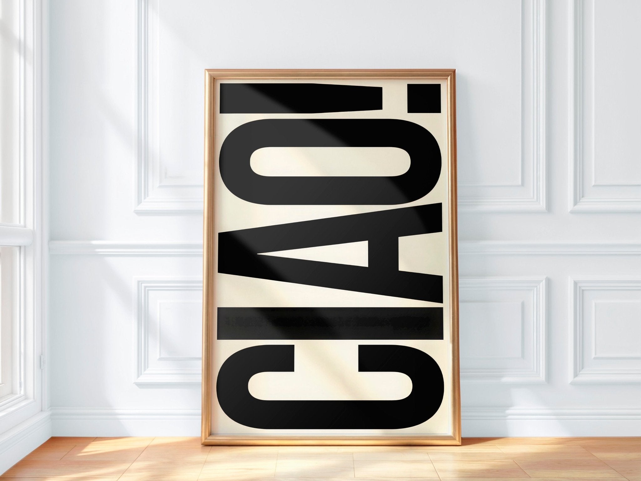 Framed artwork with the word 'CAO!' on a white wall.