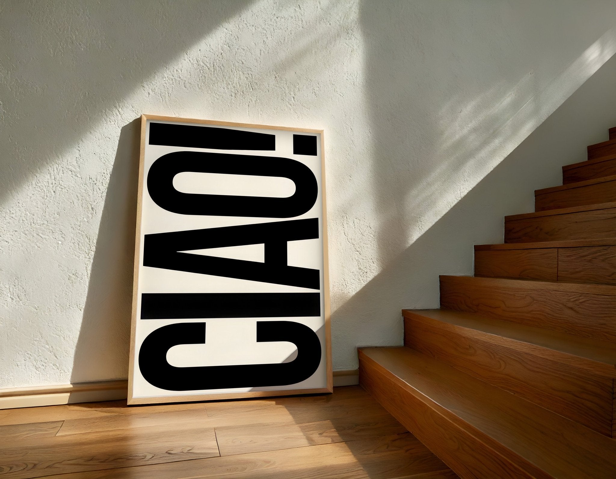 Framed artwork with 'CIAO!' text on a wall next to wooden stairs