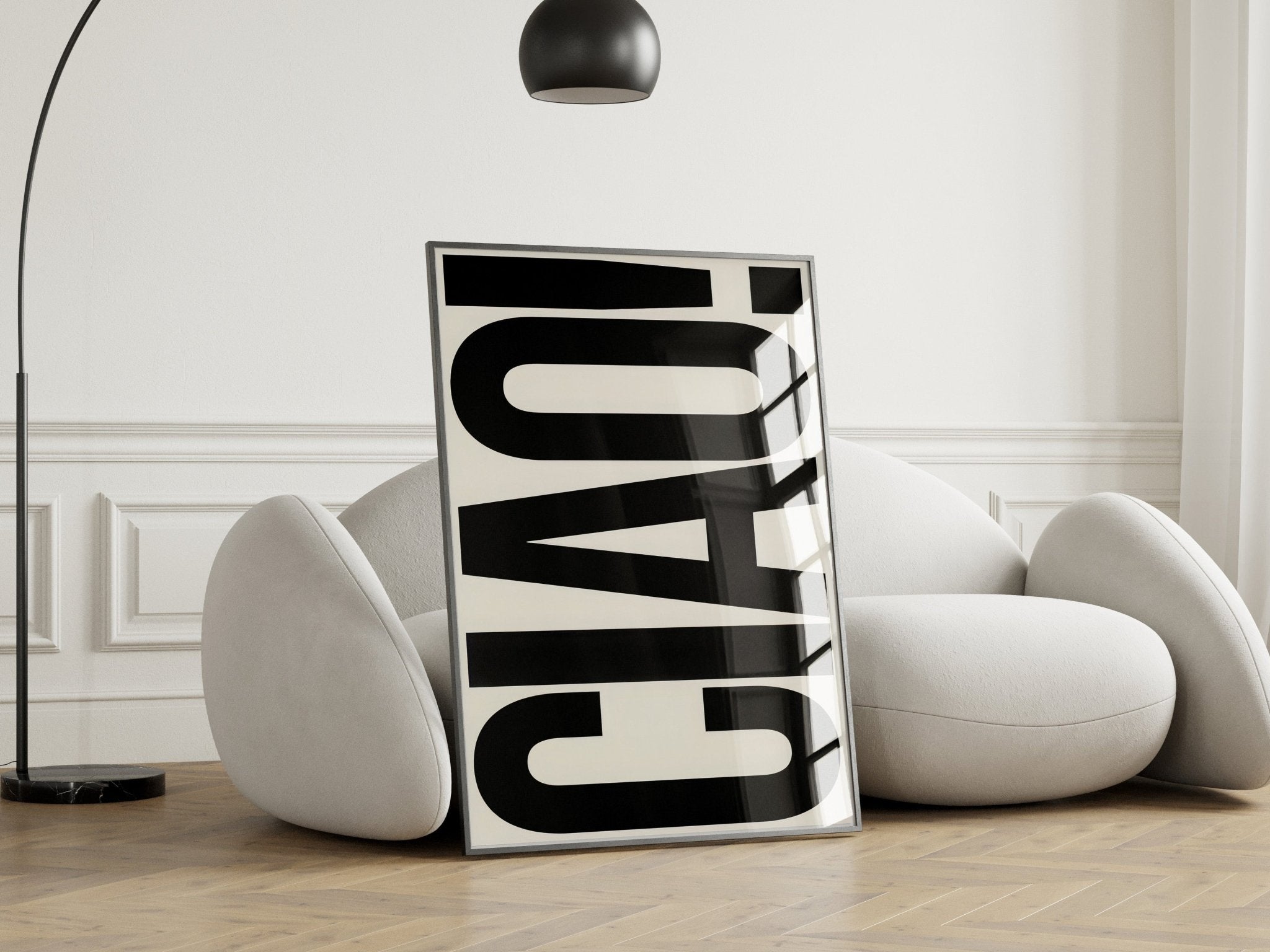 Modern interior with a white chair and a black and white abstract art piece.