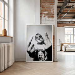 Framed artwork of a person with a microphone in a modern room with brick walls and large windows.