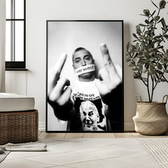 Framed poster of a person with a message on a wall in a room with decor elements.