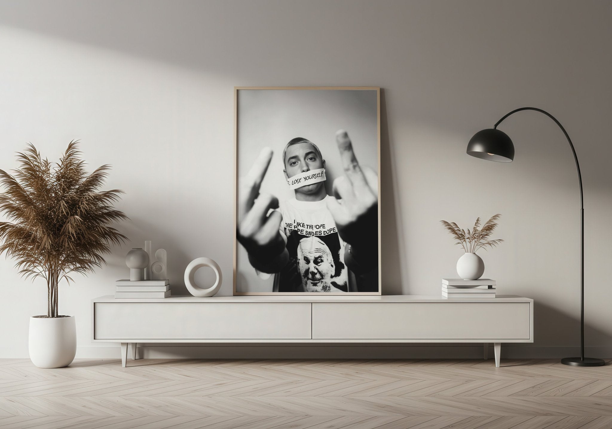 Modern living room with a framed black and white portrait on a white wall.