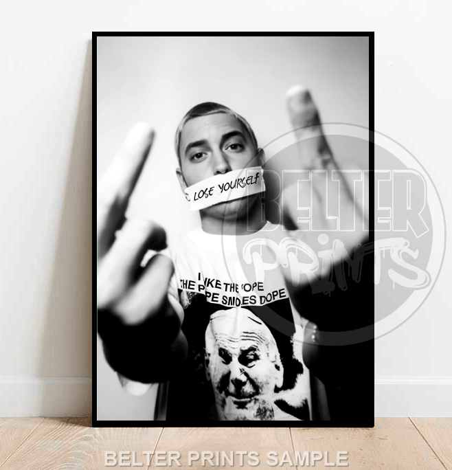 Framed poster of a person with text on tape over their mouth, wearing a shirt with a graphic design.