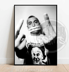 Framed poster of a person with text on tape over their mouth, wearing a shirt with a graphic design.