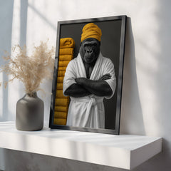 Framed artwork of a gorilla in a robe with yellow accents on a white shelf.