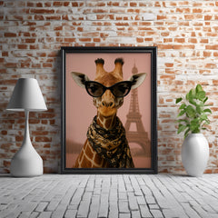 Framed artwork of a giraffe wearing sunglasses with the Eiffel Tower in the background, on a brick wall.