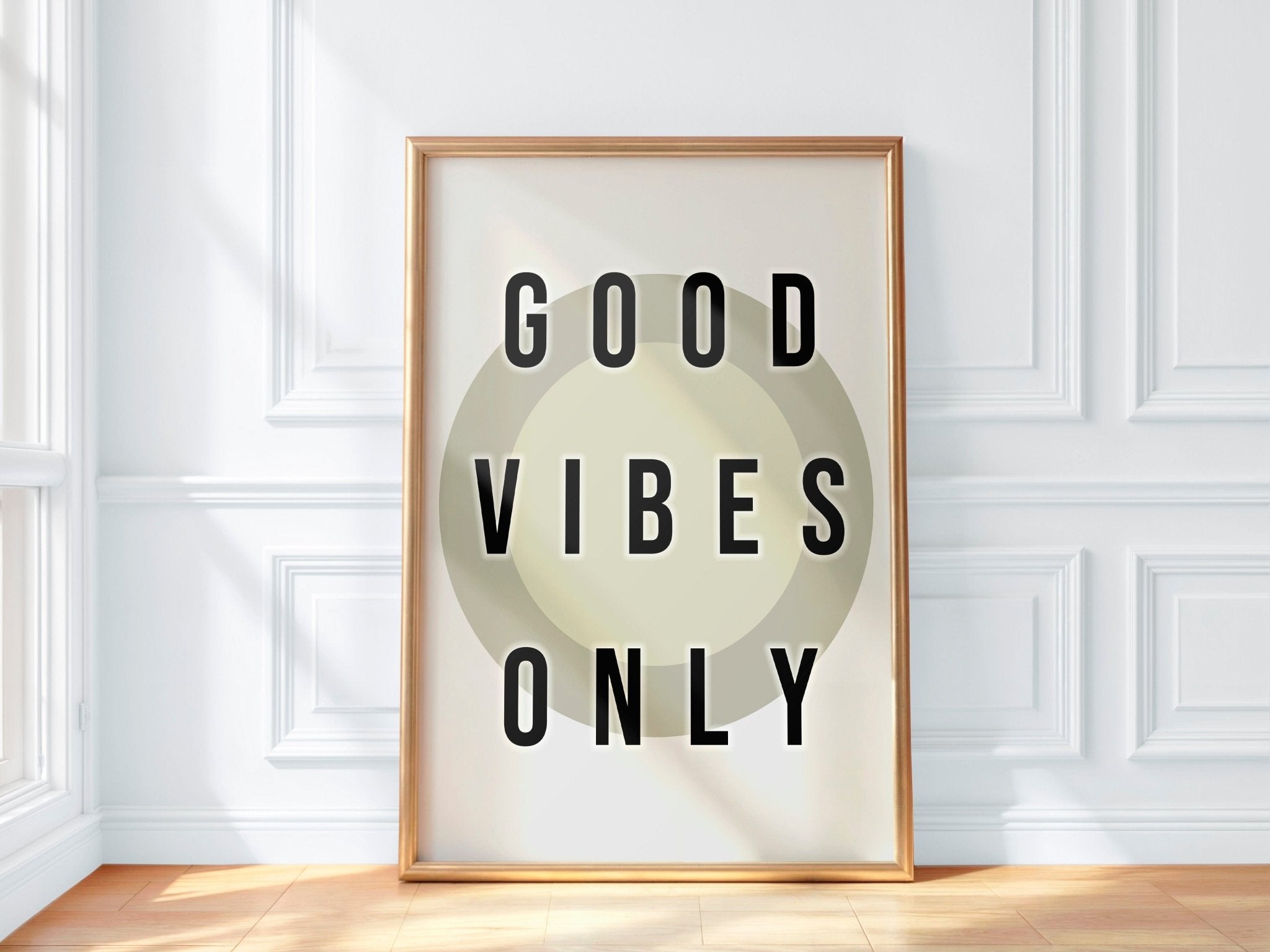 Framed artwork with 'Good Vibes Only' text on a white wall.