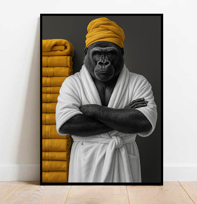 Framed artwork of a gorilla in a bathrobe with yellow towels on a white wall.