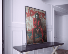 joaquin phoenix red suit sitting joker artwork