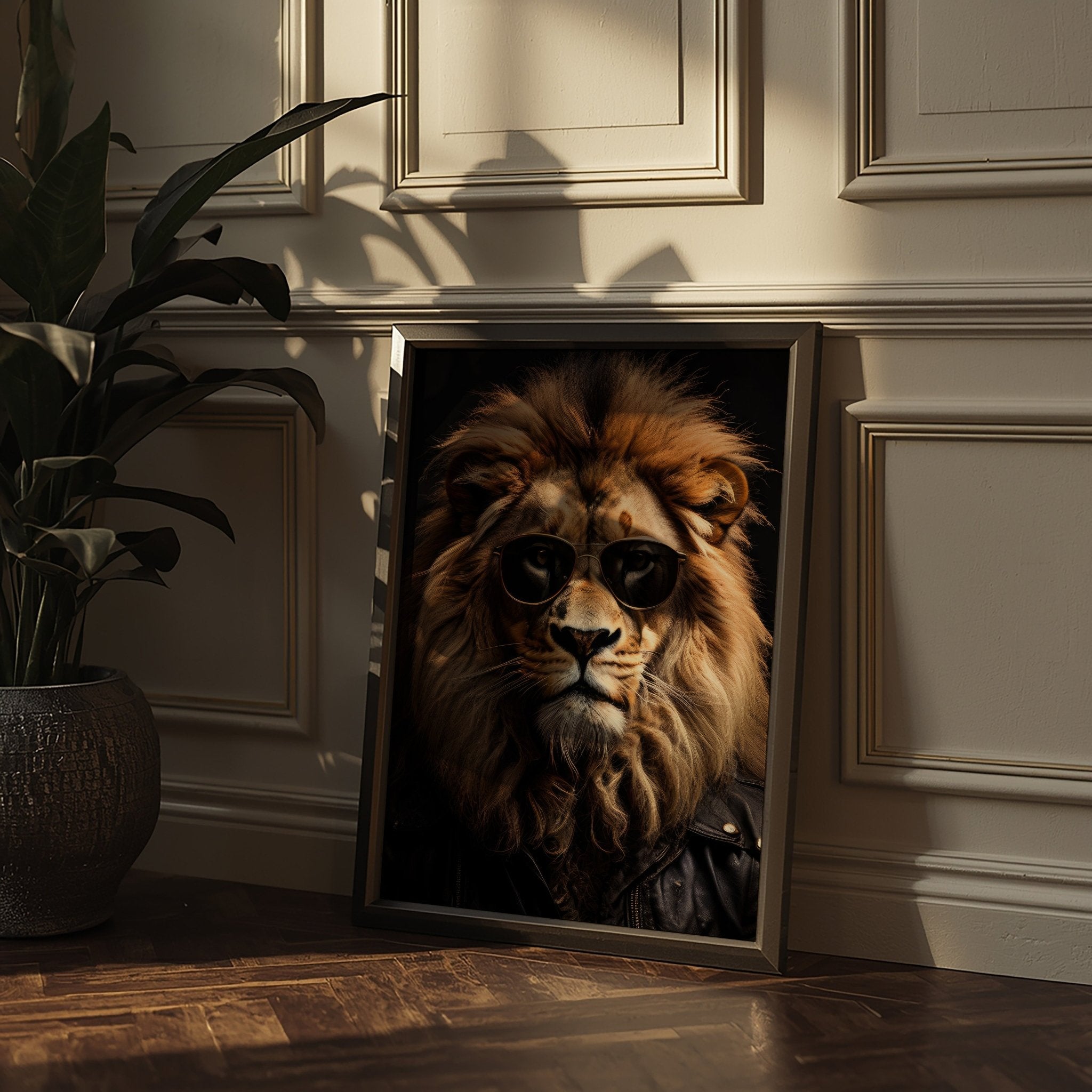 Framed picture of a lion wearing sunglasses on a wooden floor with a plant in the background.
